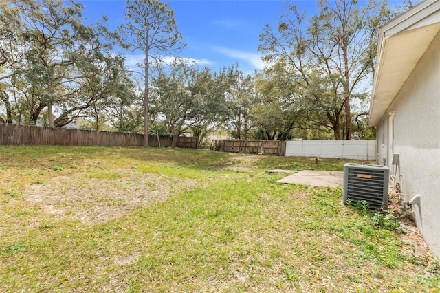 view of yard featuring a fenced backyard and central AC unit