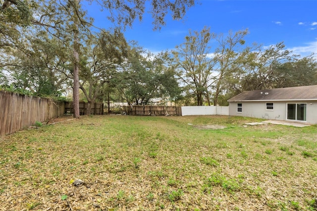 view of yard with a patio and a fenced backyard