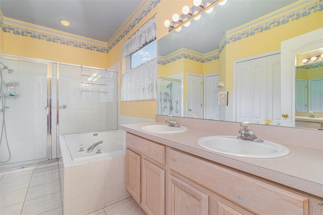 bathroom with tile patterned flooring, a garden tub, a stall shower, and a sink