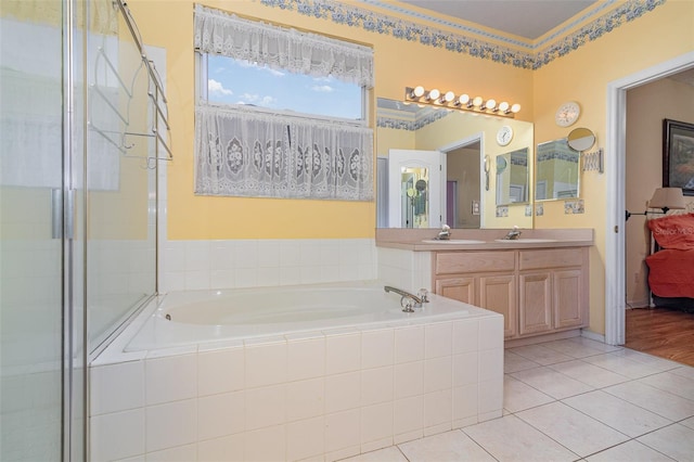 bathroom featuring tile patterned floors, an enclosed shower, a bath, and vanity