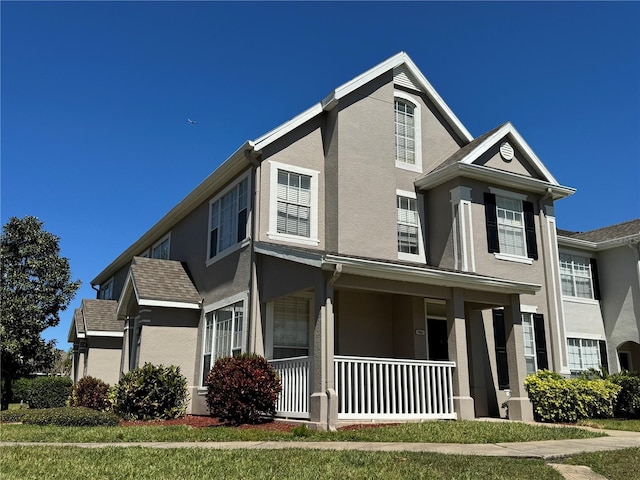 9093 Lee Vista Blvd Unit 905, Orlando, FL 32829 - view of front of house featuring covered porch and stucco siding