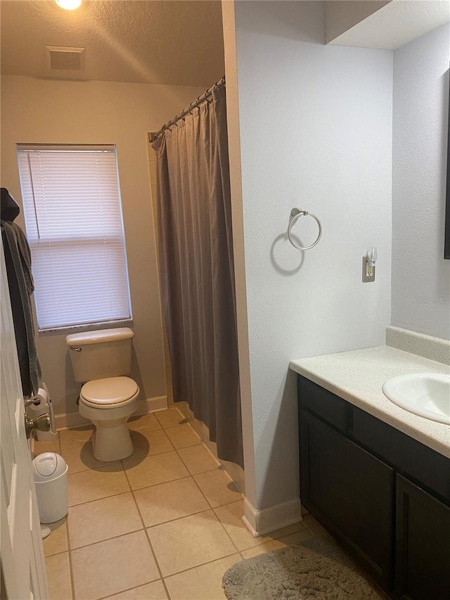 bathroom featuring vanity, visible vents, a textured ceiling, tile patterned floors, and toilet