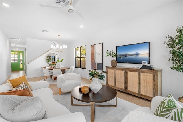 living area with a wealth of natural light, visible vents, and light wood-style flooring