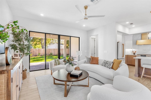 living room featuring visible vents, recessed lighting, a ceiling fan, and light wood-style floors