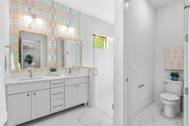 bathroom featuring a stall shower, marble finish floor, and a sink