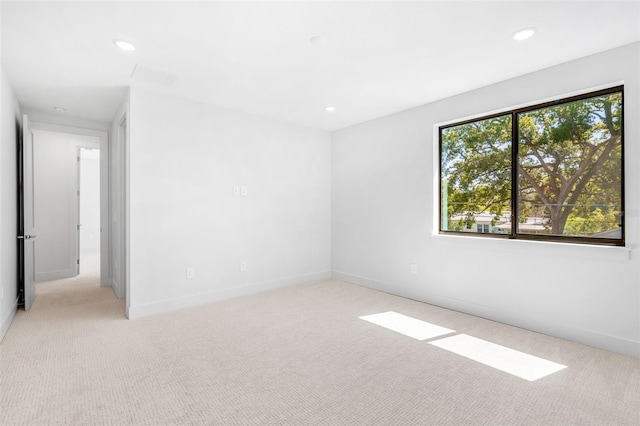 empty room featuring recessed lighting, visible vents, baseboards, and light colored carpet