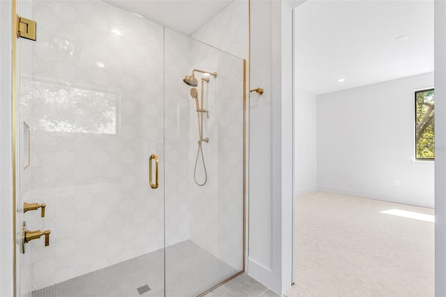 bathroom featuring a stall shower and baseboards