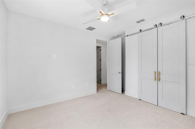 unfurnished bedroom featuring visible vents, carpet floors, baseboards, and a ceiling fan