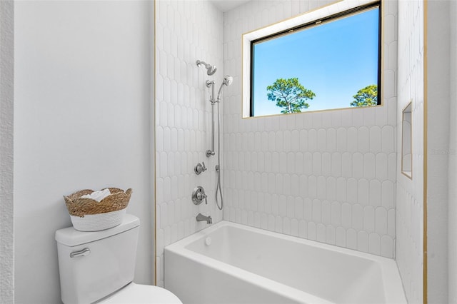 bathroom with toilet and bathing tub / shower combination