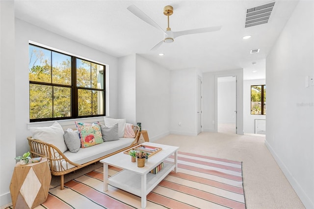 living room featuring baseboards, recessed lighting, visible vents, and light carpet