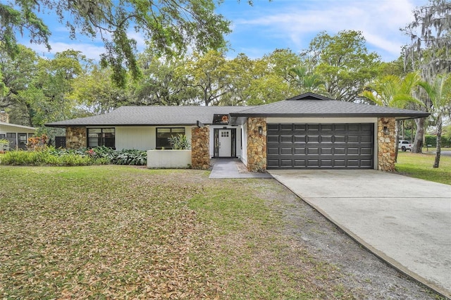 view of front of property featuring stone siding, concrete driveway, and a front lawn