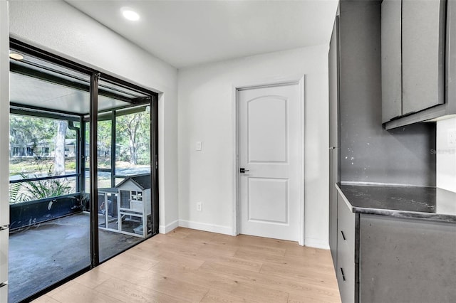 kitchen with gray cabinetry, baseboards, and light wood-style floors