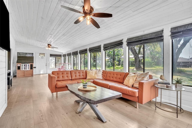 sunroom / solarium featuring a ceiling fan, vaulted ceiling, a healthy amount of sunlight, and wooden ceiling