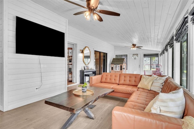 living room featuring wood finished floors, lofted ceiling, wooden ceiling, a sunroom, and a ceiling fan