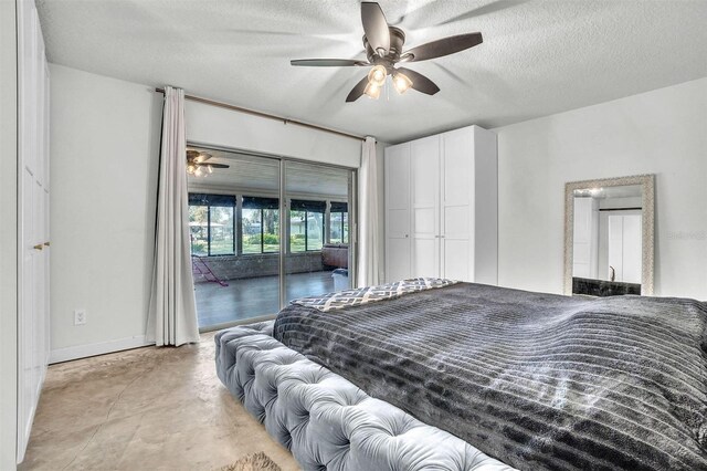 bedroom featuring access to exterior, baseboards, concrete flooring, a textured ceiling, and a ceiling fan