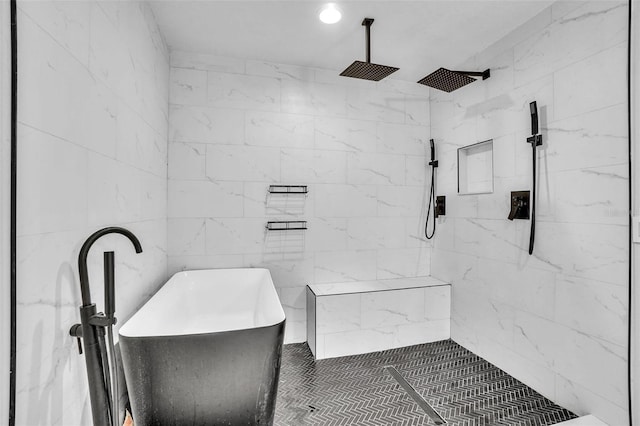 full bathroom featuring a tile shower and a freestanding bath