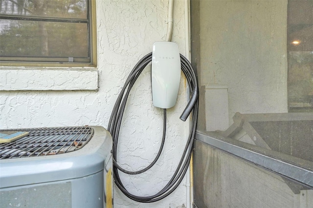 exterior details with cooling unit and stucco siding