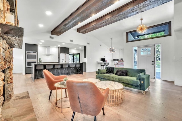 living room with beam ceiling, a chandelier, high vaulted ceiling, light wood finished floors, and recessed lighting