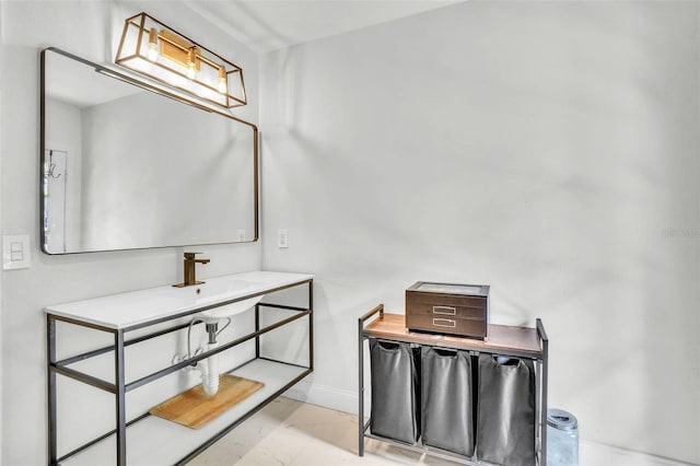 bathroom with a sink and baseboards