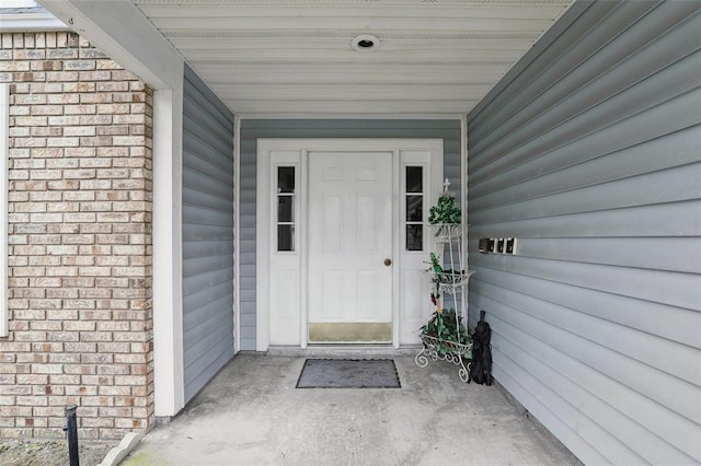 property entrance featuring brick siding