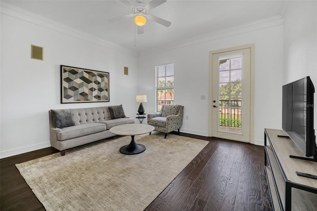 living room featuring ornamental molding, dark wood-style flooring, visible vents, and baseboards