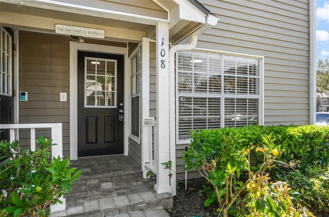 view of exterior entry with covered porch