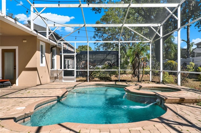 view of pool with a pool with connected hot tub, a lanai, and a patio