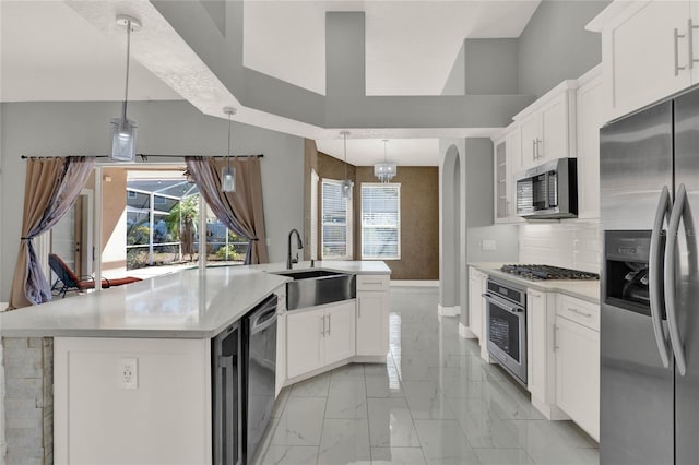 kitchen with marble finish floor, appliances with stainless steel finishes, light countertops, and a sink