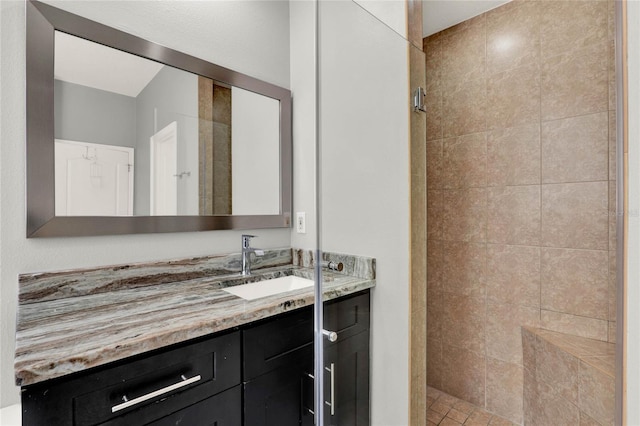 full bathroom featuring a stall shower and vanity