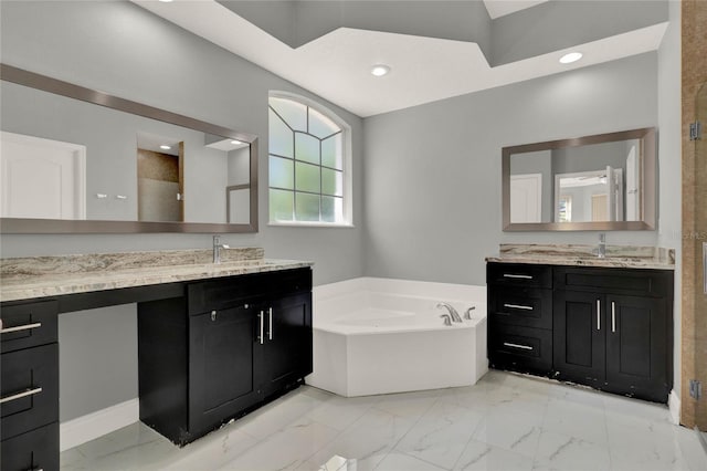 bathroom with a sink, marble finish floor, a garden tub, a shower stall, and two vanities