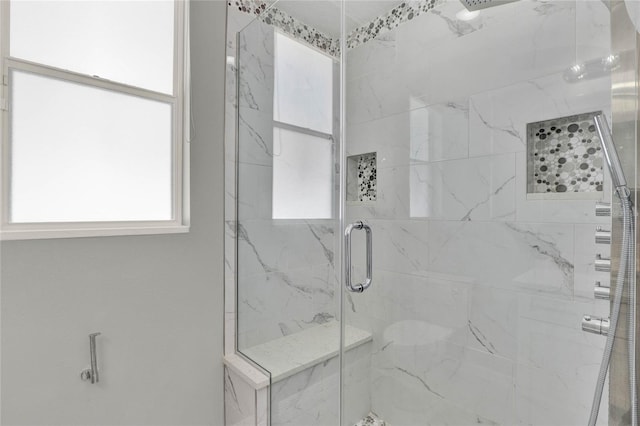 bathroom with a marble finish shower