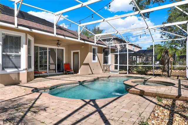 view of swimming pool with glass enclosure, ceiling fan, and a patio area