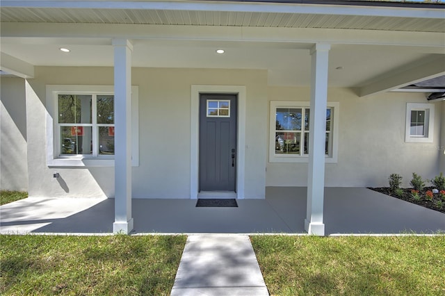 doorway to property with stucco siding