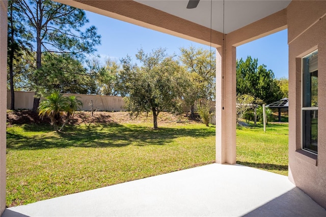 view of yard featuring a patio area, fence, and a ceiling fan