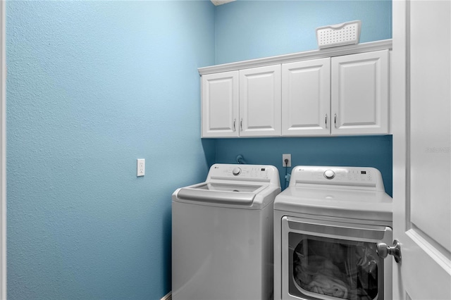 laundry room with cabinet space and separate washer and dryer