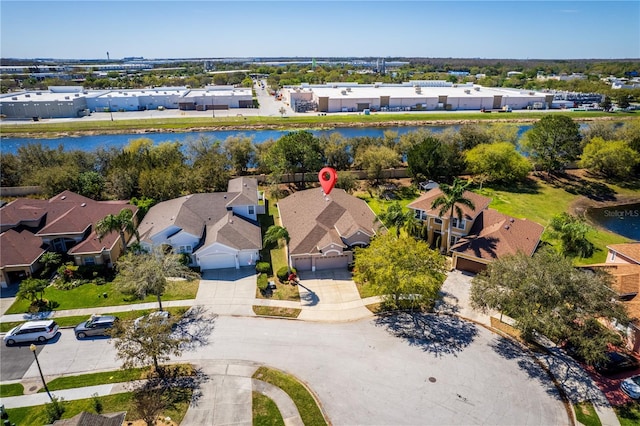 bird's eye view featuring a water view and a residential view