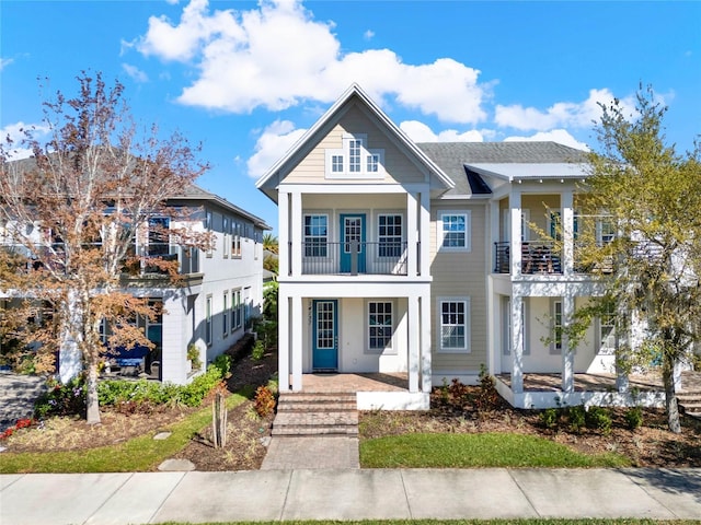 view of front of home with a porch and a balcony