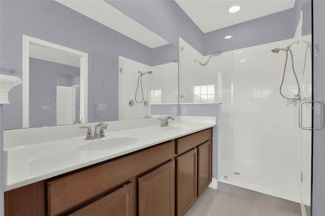 full bath featuring tiled shower and a sink