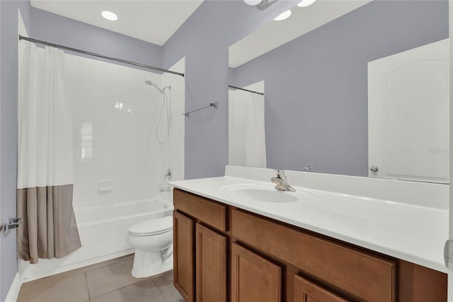 full bath with tile patterned floors, shower / tub combo with curtain, vanity, and toilet