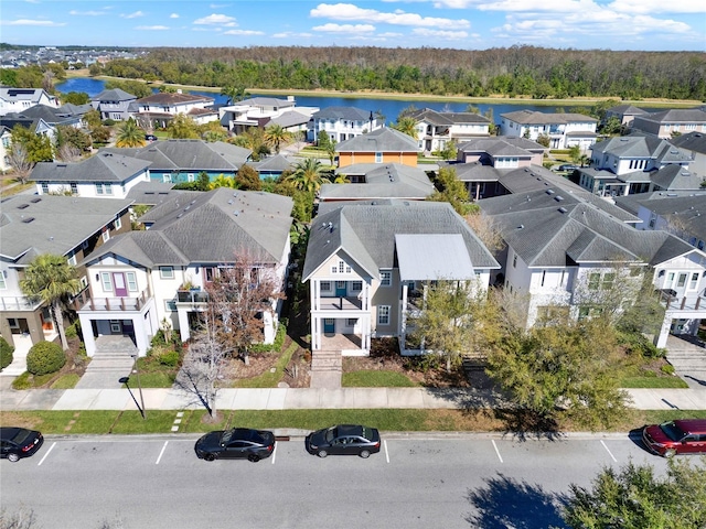 drone / aerial view featuring a residential view and a water view