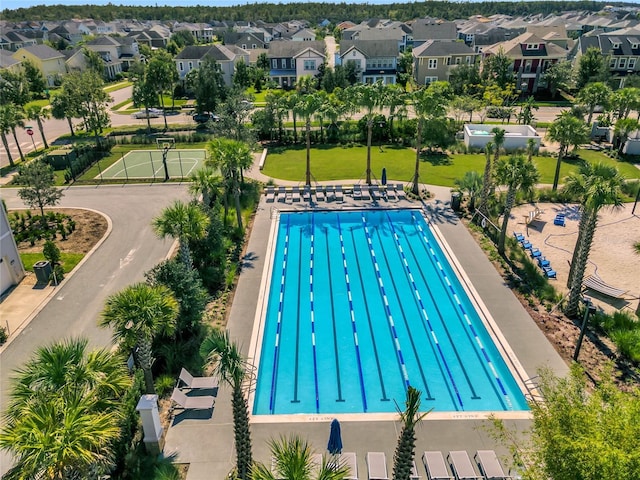 view of swimming pool featuring a residential view and a lawn