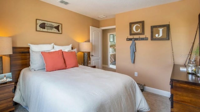 bedroom featuring carpet floors, visible vents, and baseboards