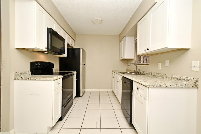 kitchen featuring light tile patterned floors, a textured ceiling, a sink, white cabinetry, and black appliances