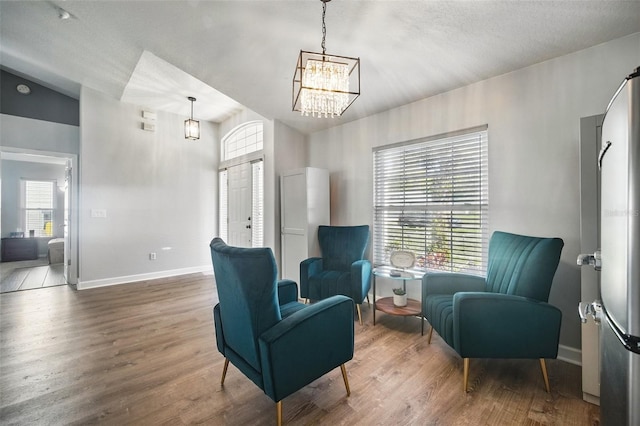 living area featuring plenty of natural light, baseboards, and wood finished floors