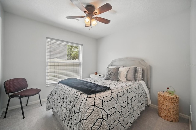 carpeted bedroom featuring a ceiling fan and baseboards