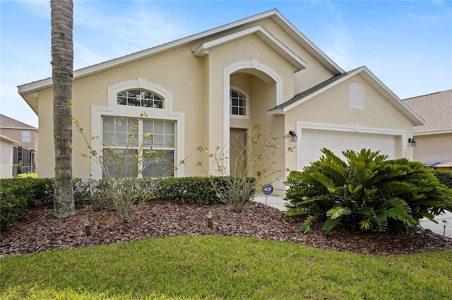 view of front of home with stucco siding and an attached garage