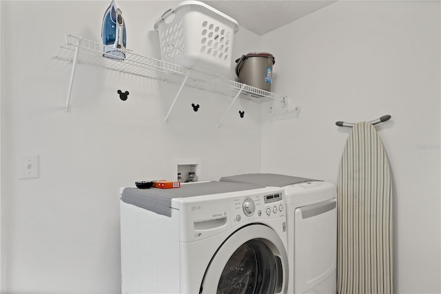 washroom with washer and clothes dryer and laundry area