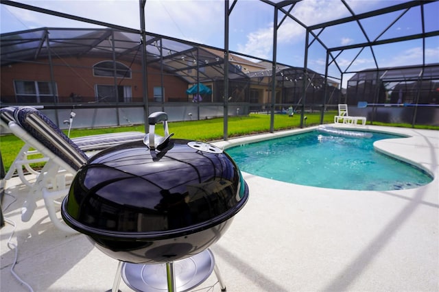 pool featuring glass enclosure, a patio, and a yard