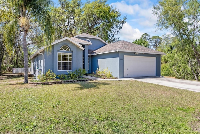 ranch-style home with a garage, stucco siding, concrete driveway, and a front yard