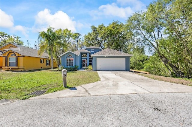 single story home with driveway, a garage, a front lawn, and stucco siding